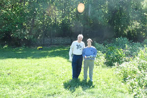 Andy (Roanoke) and Peg (Westport) beside the debris pile that had hidden the section of stone wall in the background just an hour before.