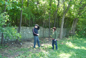 Pam (Volker) beseeches Park Community Organizer Miles Krivena  to add just one more giant honeysuckle bush to the debris pile for pickup on Monday by the park department.